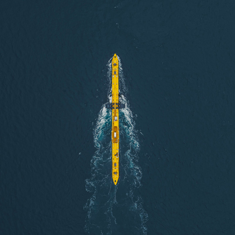 Overhead view of the yellow Orbital Marine Power O2 turbine with a wake showing it is generating